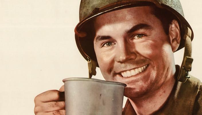 Smiling WWII GI drinking coffee