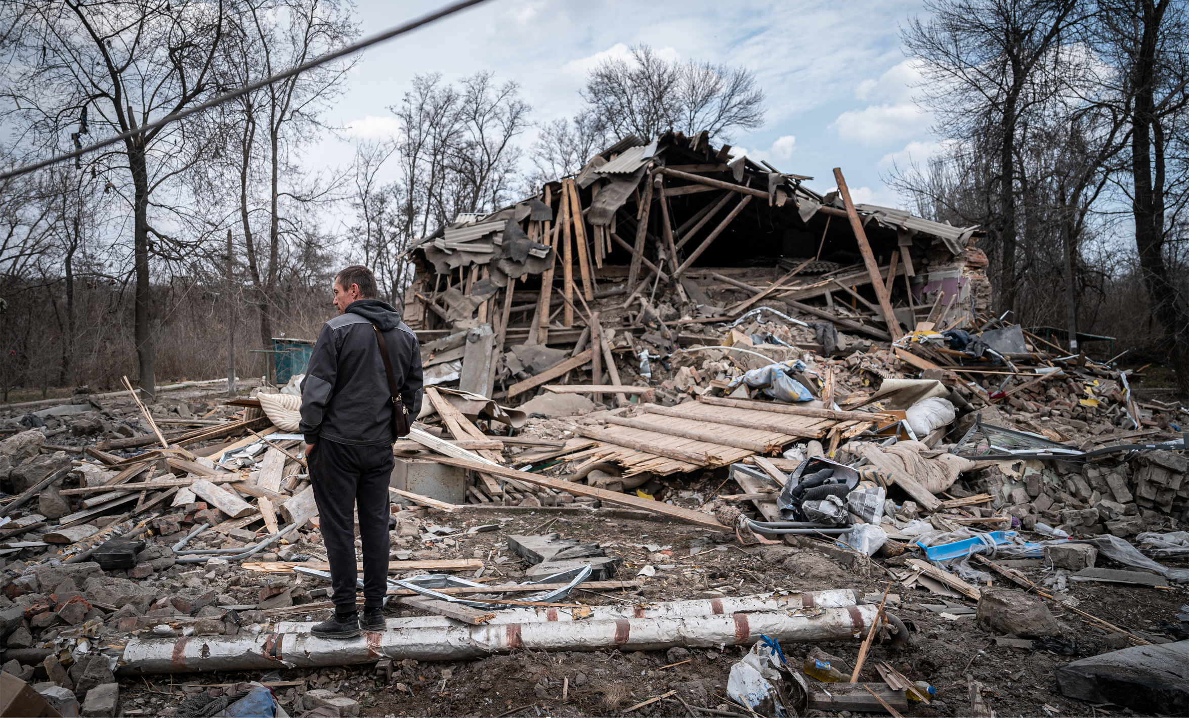 A man looks at the debris after a Russian rocket attack on a residential building for refugees in Kostyantynivka, Ukraine, March 24 2023. Photo by Ignacio Marin/Anadolu Agency via Getty Images.