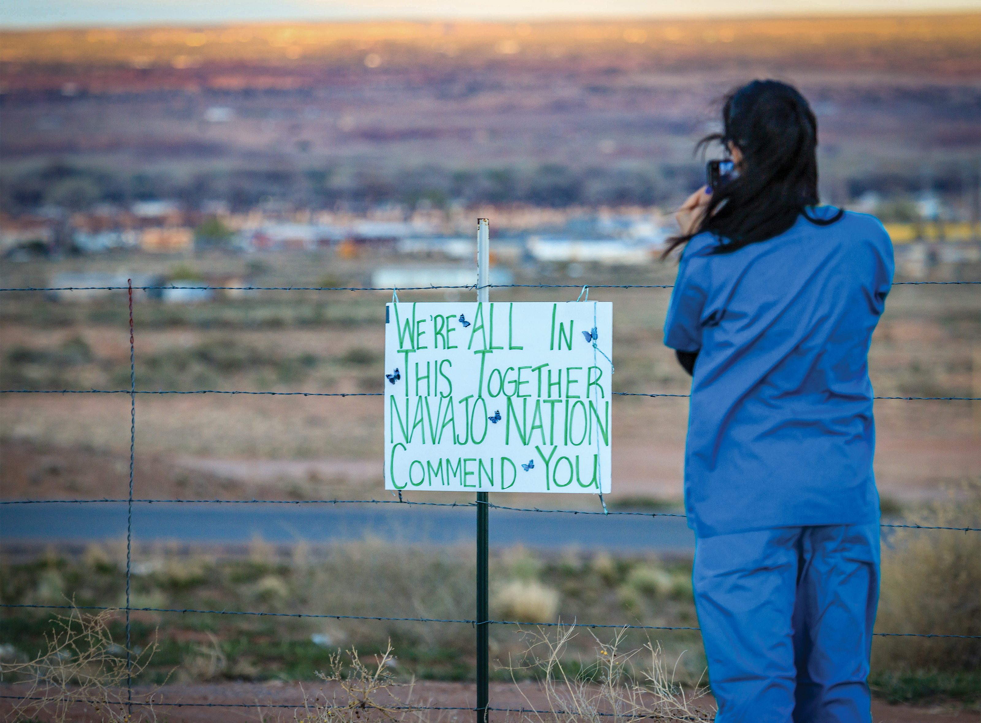 A nurse practitioner snaps a photo on April 8 in Apache County, Arizona—the middle of the Navajo Nation. Beside her, a handmade sign thanks local hospital staff during the pandemic. 