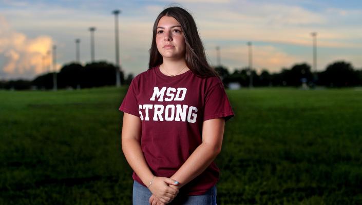 Wearing a shirt that says "MSD Strong," Sari Kaufman stands on the empty football field at Marjorie Stoneman Douglass High School in Parkland, Florida.
