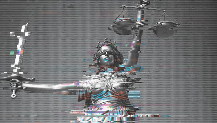 An image of a statue of holding a set of scales in one hand and a sword in the other, overlaid with a computer code.