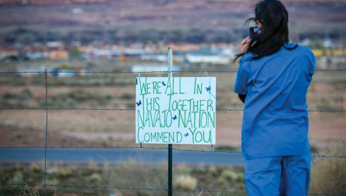 A nurse practitioner snaps a photo on April 8 in Apache County, Arizona—the middle of the Navajo Nation. Beside her, a handmade sign thanks local hospital staff during the pandemic. 