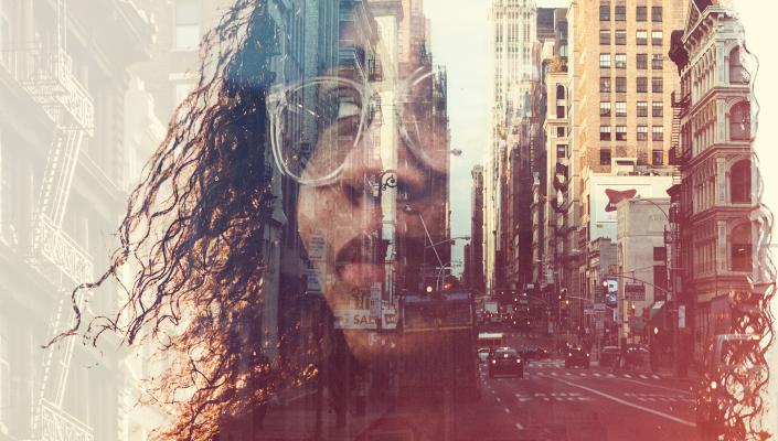 Person of color superimposed over a city streetscape.