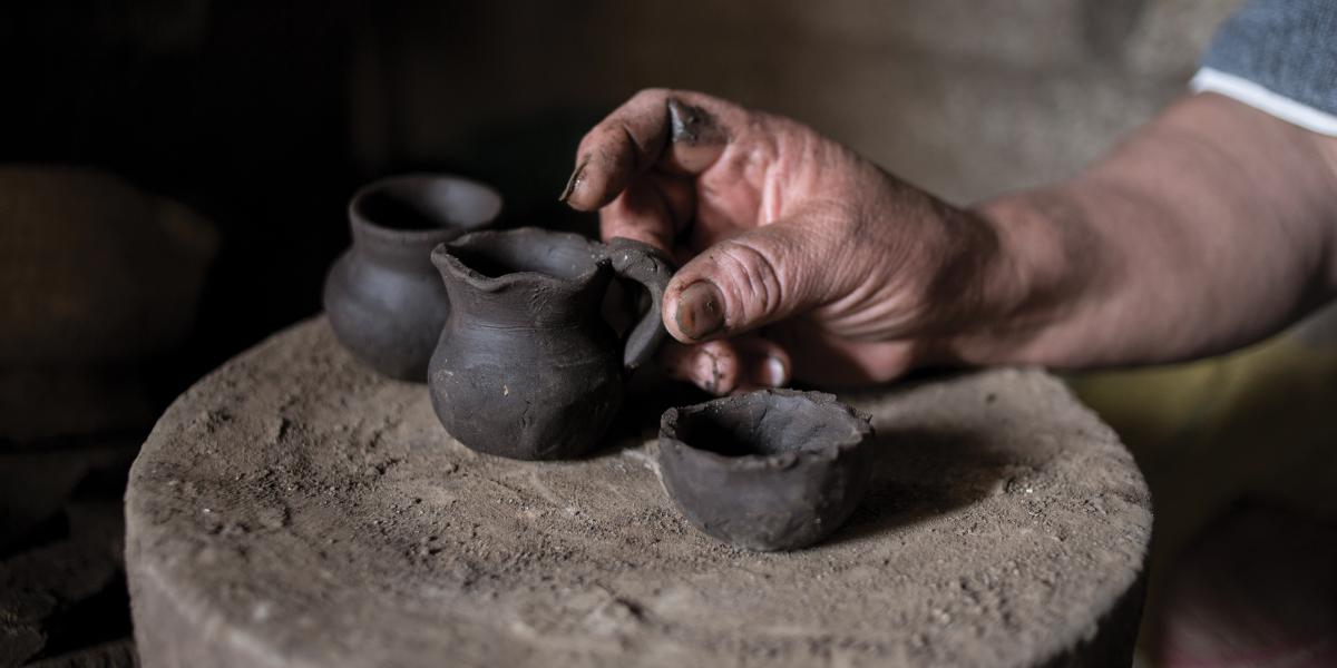 An artisan displays some of his pots.