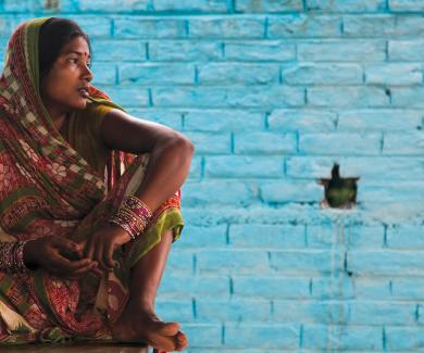Sunita Kumari sits outside a community toilet facility