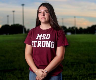 Wearing a shirt that says "MSD Strong," Sari Kaufman stands on the empty football field at Marjorie Stoneman Douglass High School in Parkland, Florida.