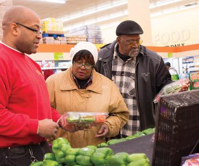 Theodora and Eugene Morris (married for 45 years) discuss the bell peppers with Food Depot produce manager Dominic Wilson.