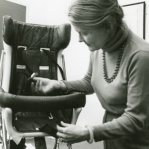 Sue Baker demonstrating an early child safety seat